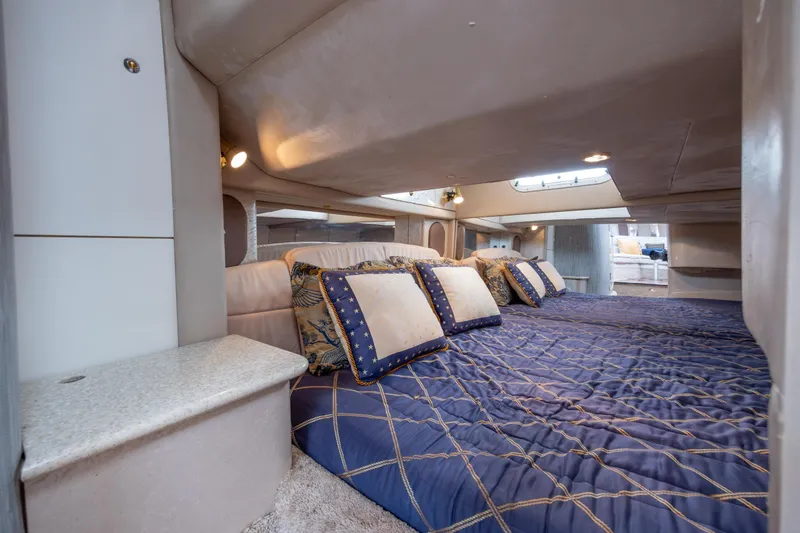 Slide: The Image of Luxurious cabin interior of a 2003 Formula 400 Super Sport yacht with plush bedding. - 27