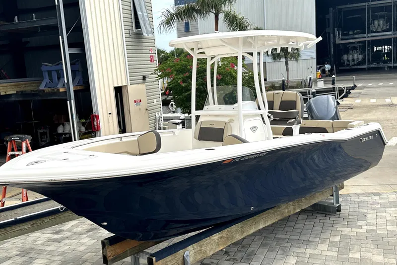 The Image of 2018 Tidewater 220 LXF boat with T-top, docked at marina. - 0