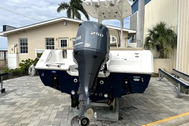 Slide: The Image of 2018 Tidewater 220 LXF boat with Yamaha 250 engine, parked on paved area. - 2