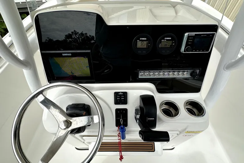 Slide: The Image of 2018 Tidewater 220 LXF boat dashboard with steering wheel and navigation controls. - 7