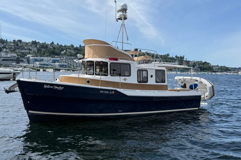 The Image of 2020 Ranger Tugs R-31 CB boat on water, scenic background, clear sky. - 0