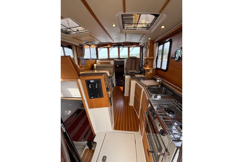 Slide: The Image of Interior of 2020 Ranger Tugs R-31 CB, featuring wood accents and modern amenities. - 13