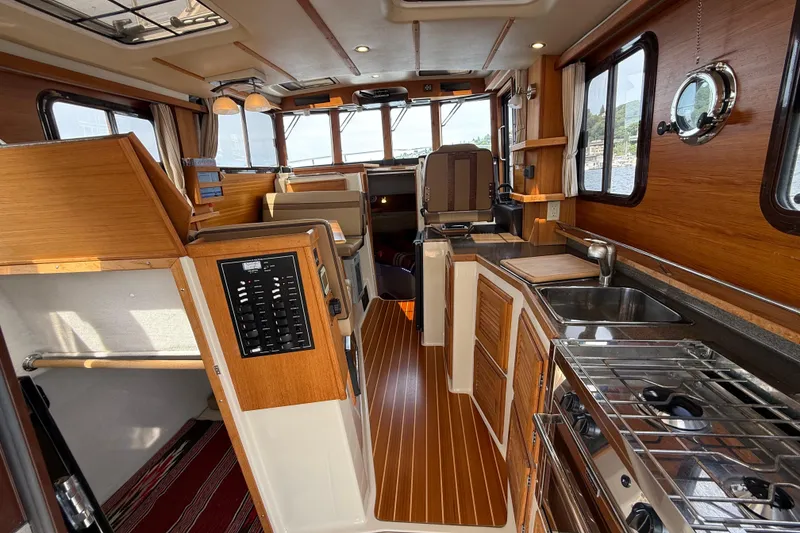 Slide: The Image of Interior of 2020 Ranger Tugs R-31 CB, featuring wood finishes and modern amenities. - 14