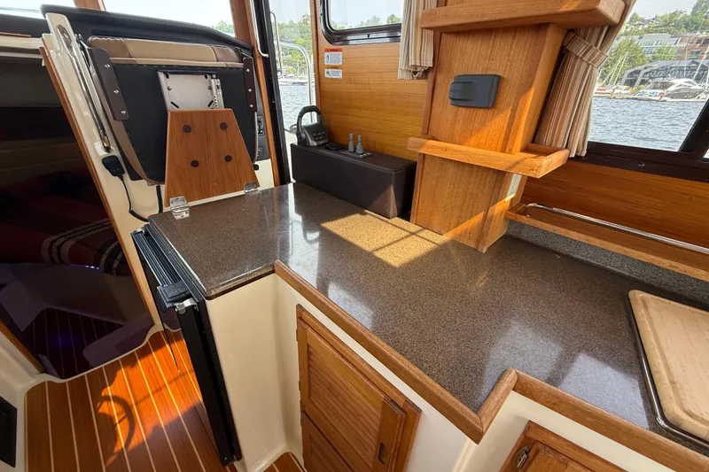 Slide: The Image of Interior of 2020 Ranger Tugs R-31 CB with wooden cabinetry and countertop. - 22