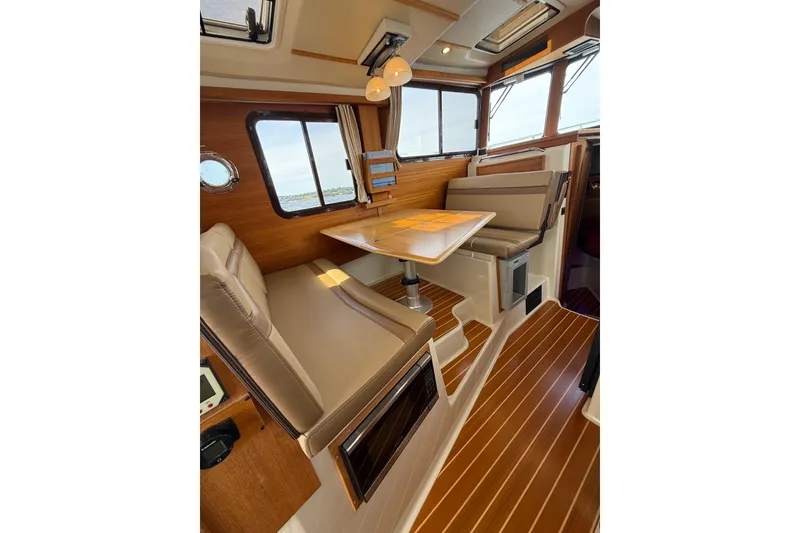 Slide: The Image of Interior of 2020 Ranger Tugs R-31 CB with elegant seating and wooden finishes. - 23