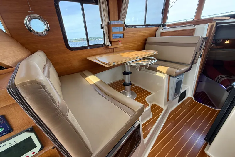 Slide: The Image of 2020 Ranger Tugs R-31 CB interior with wood accents and seating area. - 25