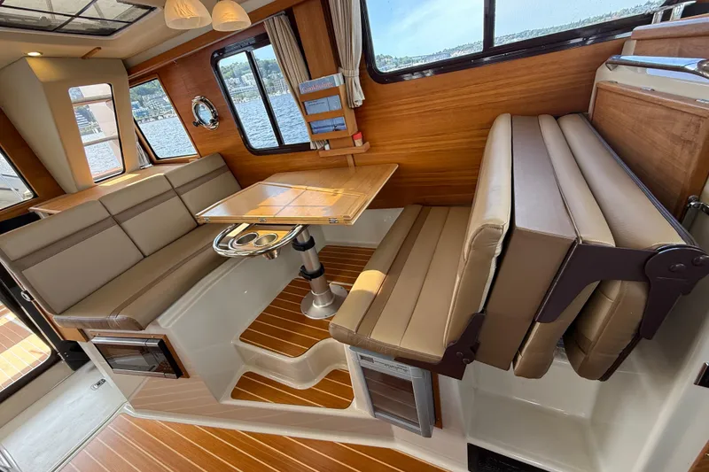 Slide: The Image of Interior of 2020 Ranger Tugs R-31 CB with elegant seating and wooden accents. - 26