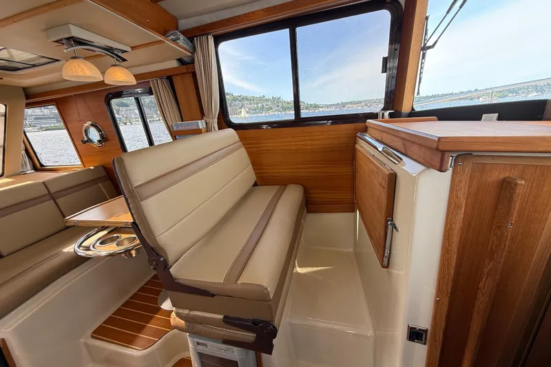 Slide: The Image of Interior of 2020 Ranger Tugs R-31 CB, featuring elegant wood finishes and comfortable seating. - 27