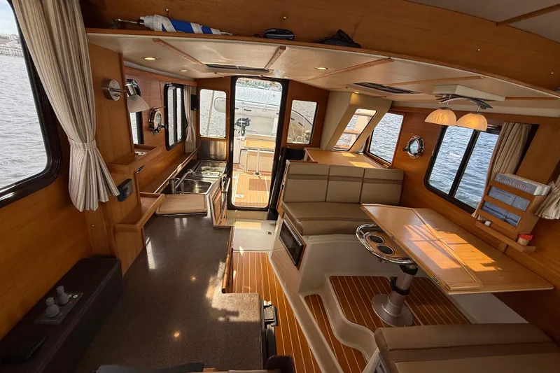 Slide: The Image of Interior of 2020 Ranger Tugs R-31 CB boat with wood finish and seating area. - 28