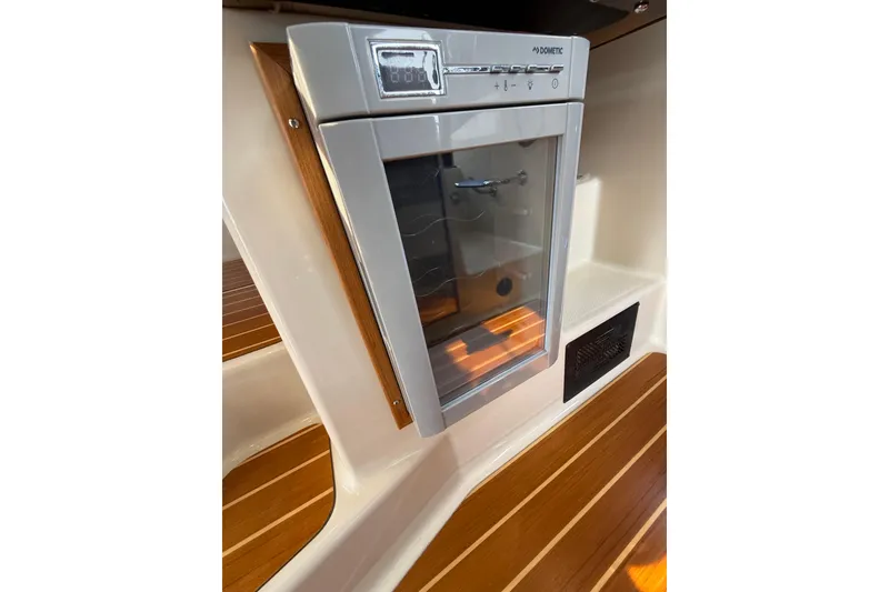 Slide: The Image of 2020 Ranger Tugs R-31 CB interior with Dometic fridge and wooden flooring. - 30