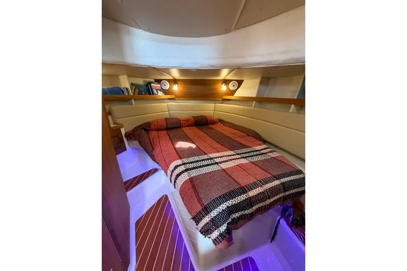 Slide: The Image of Cozy cabin interior of 2020 Ranger Tugs R-31 CB with bed and ambient lighting. - 34