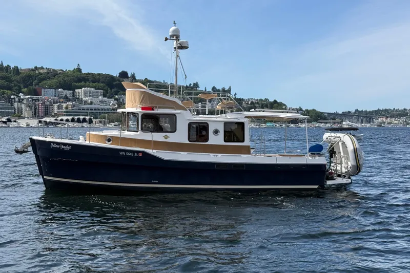 Slide: The Image of 2020 Ranger Tugs R-31 CB boat on water, cityscape background. - 4