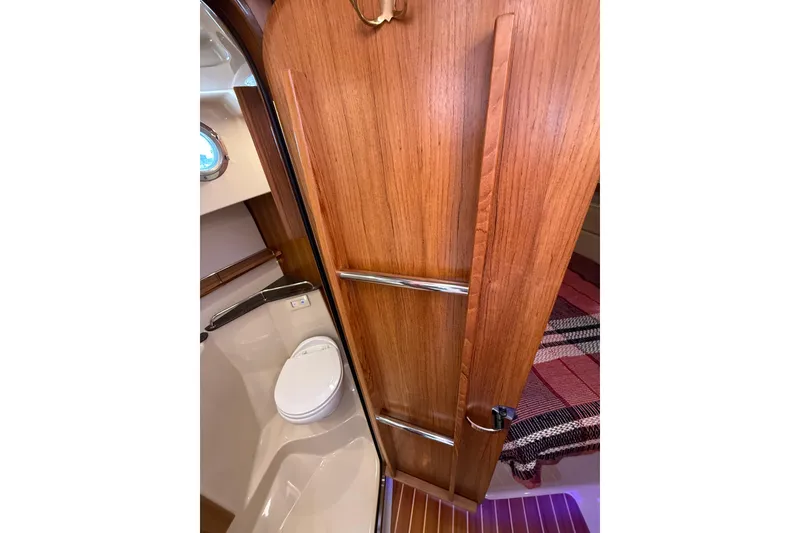 Slide: The Image of 2020 Ranger Tugs R-31 CB bathroom with wooden door and modern fixtures. - 40