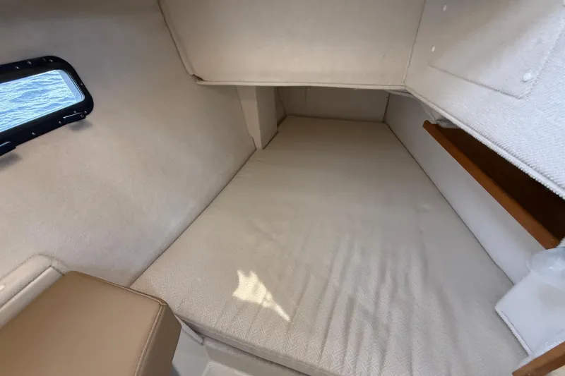 Slide: The Image of 2020 Ranger Tugs R-31 CB cabin interior with bed and window view. - 41