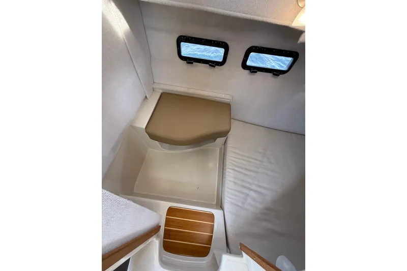 Slide: The Image of 2020 Ranger Tugs R-31 CB cabin interior with windows and seating area. - 42