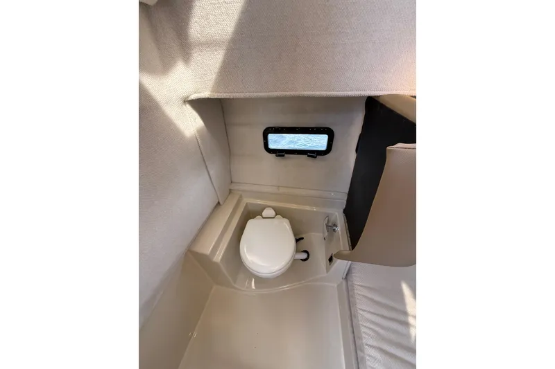 Slide: The Image of 2020 Ranger Tugs R-31 CB interior bathroom with compact toilet and window. - 43