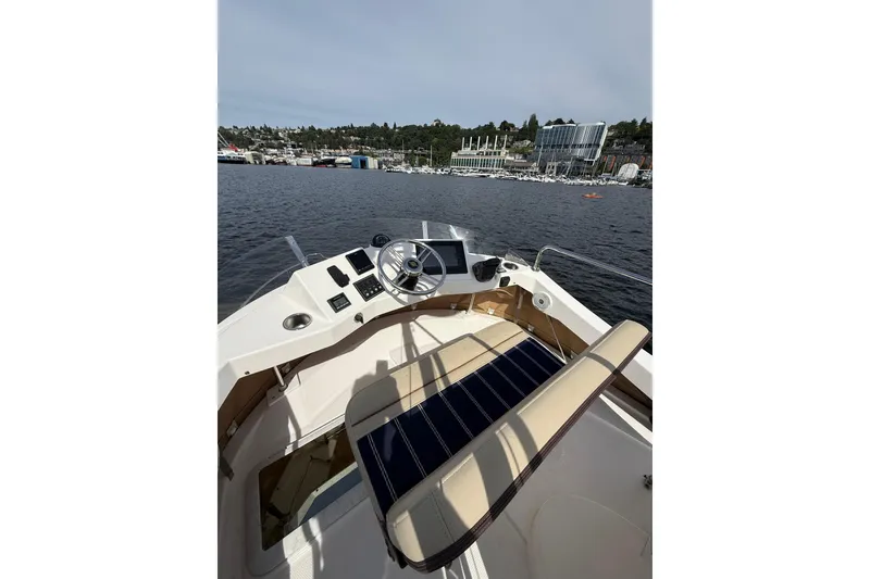 Slide: The Image of 2020 Ranger Tugs R-31 CB boat helm with waterfront view. - 46