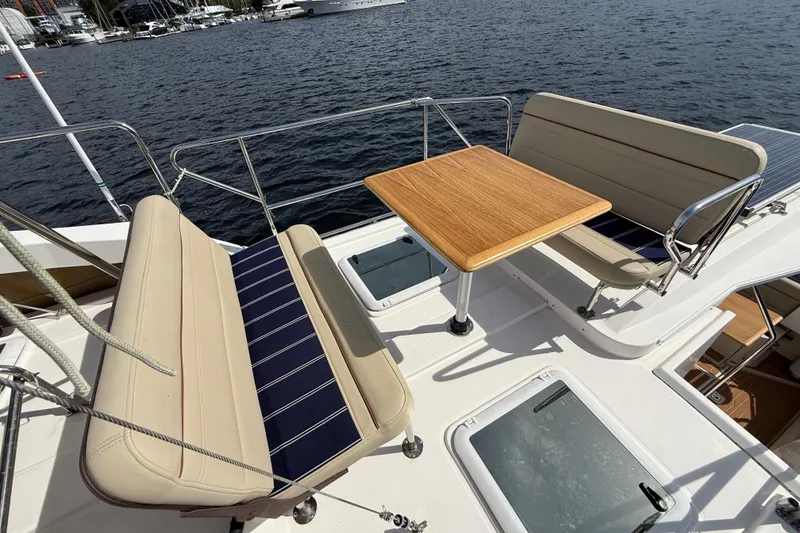 Slide: The Image of Flybridge seating area on 2020 Ranger Tugs R-31 CB with table, overlooking marina. - 47