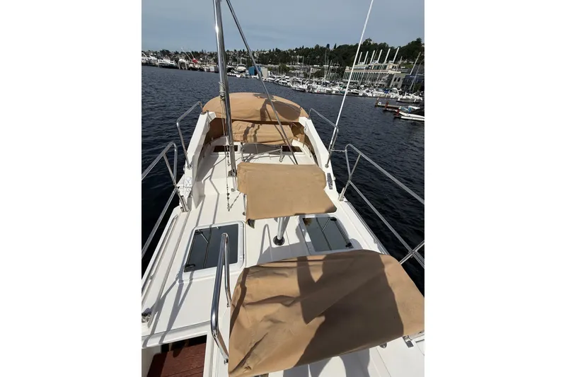 Slide: The Image of 2020 Ranger Tugs R-31 CB boat deck with tan covers, docked at marina. - 48