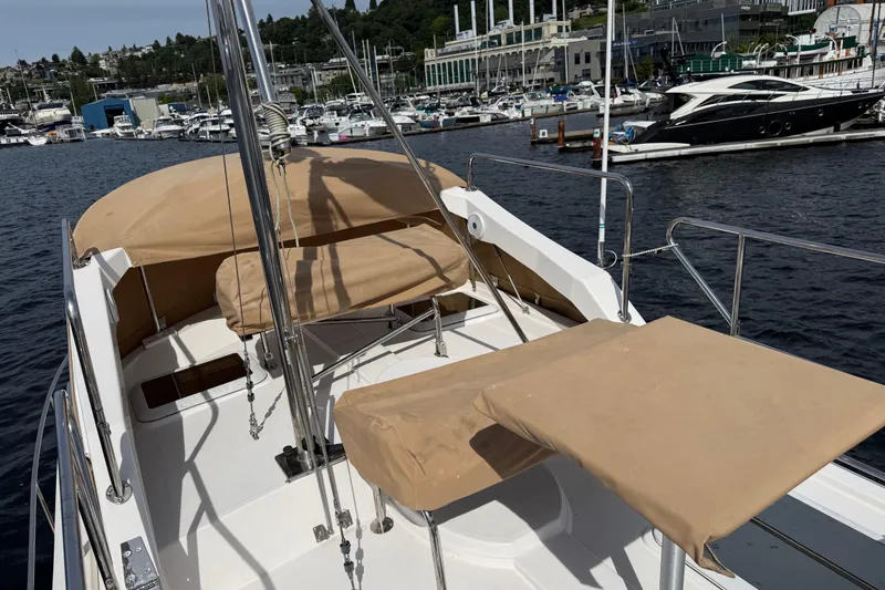 Slide: The Image of 2020 Ranger Tugs R-31 CB boat deck with tan covers, docked at marina. - 50
