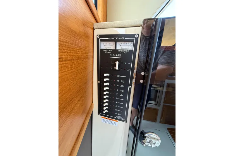 Slide: The Image of Electrical panel on 2020 Ranger Tugs R-31 CB boat, featuring switches and voltage meter. - 51