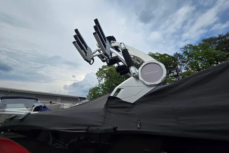 Slide: The Image of 2019 MasterCraft XT25 boat with covered deck and wakeboard tower under cloudy sky. - 13
