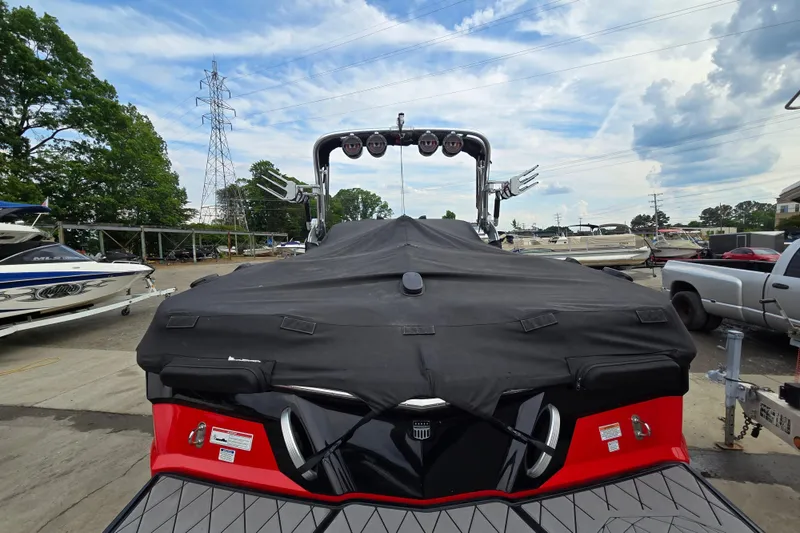 Slide: The Image of 2019 MasterCraft XT25 boat with cover in a marina setting. - 14
