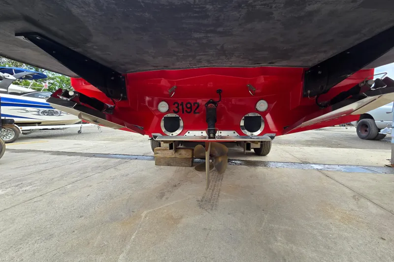 Slide: The Image of Rear view of a 2019 MasterCraft XT25 boat on a trailer, showcasing the propeller and hull. - 15