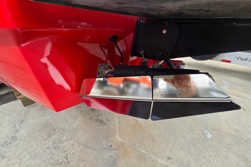 Slide: The Image of 2019 MasterCraft XT25 boat with red hull and patented metal component detail. - 17