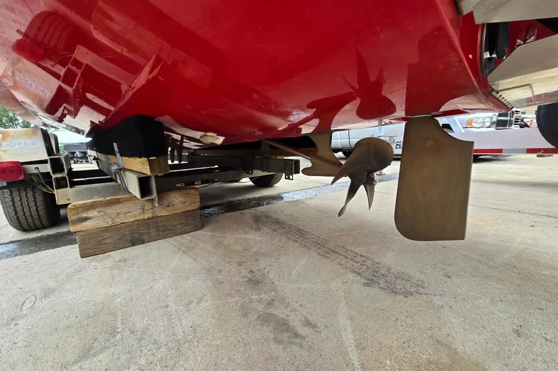 Slide: The Image of 2019 MasterCraft XT25 boat underside showing propeller and rudder on trailer. - 18