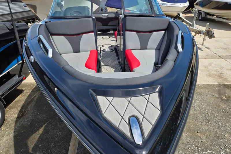Slide: The Image of 2019 MasterCraft XT25 boat with sleek black exterior and stylish interior seating. - 24