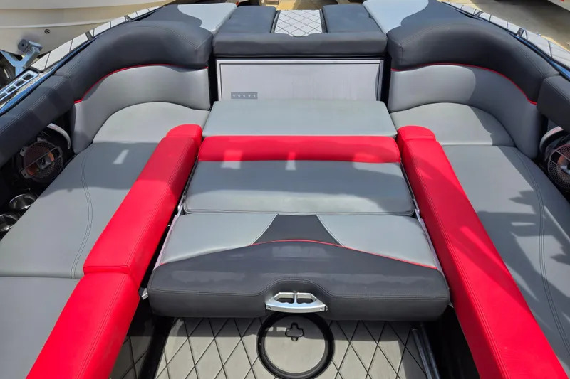 Slide: The Image of 2019 MasterCraft XT25 boat interior with red and gray seating. - 28