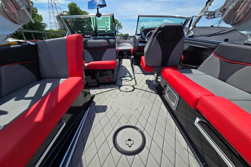 Slide: The Image of 2019 MasterCraft XT25 boat interior with red and gray seating, modern design, and spacious layout. - 30