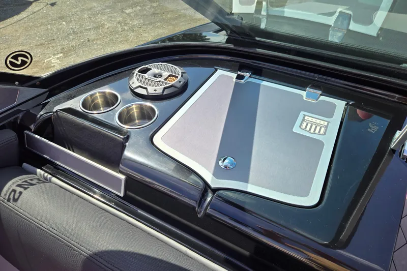 Slide: The Image of 2019 MasterCraft XT25 boat interior with cup holders and speaker. - 31