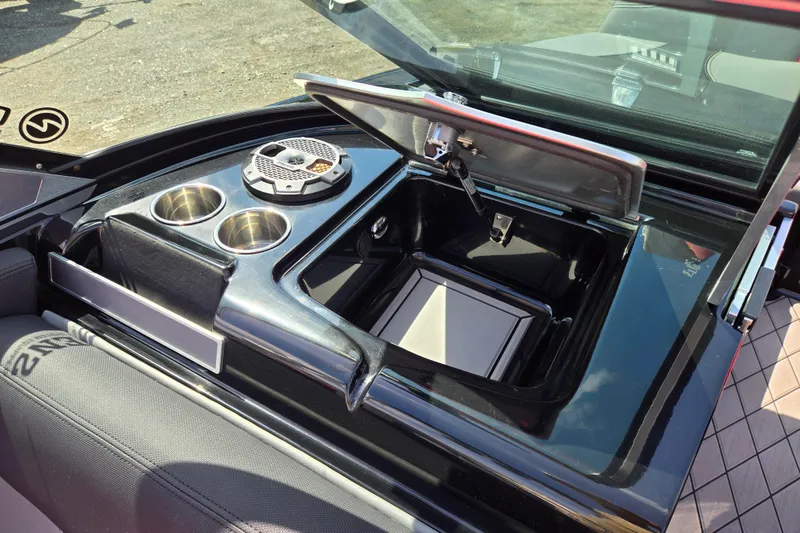 Slide: The Image of 2019 MasterCraft XT25 boat interior with cup holders and storage compartment. - 32