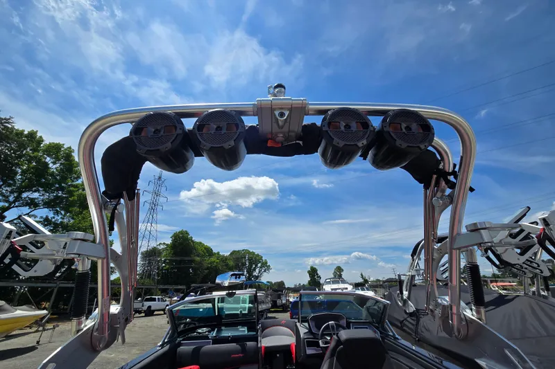Slide: The Image of 2019 MasterCraft XT25 boat with tower speakers under a clear blue sky. - 34