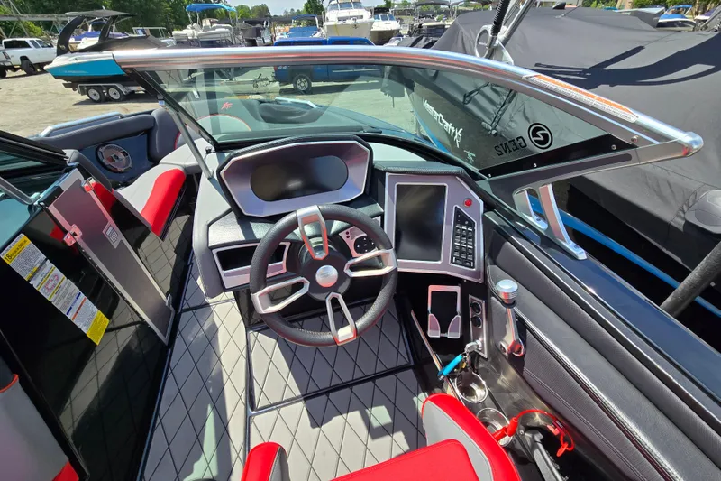 Slide: The Image of 2019 MasterCraft XT25 boat interior with modern dashboard and steering wheel. - 36