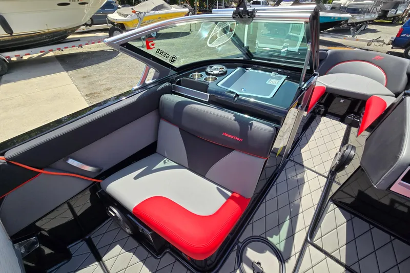 Slide: The Image of 2019 MasterCraft XT25 boat interior with red and gray seating, sleek design. - 37