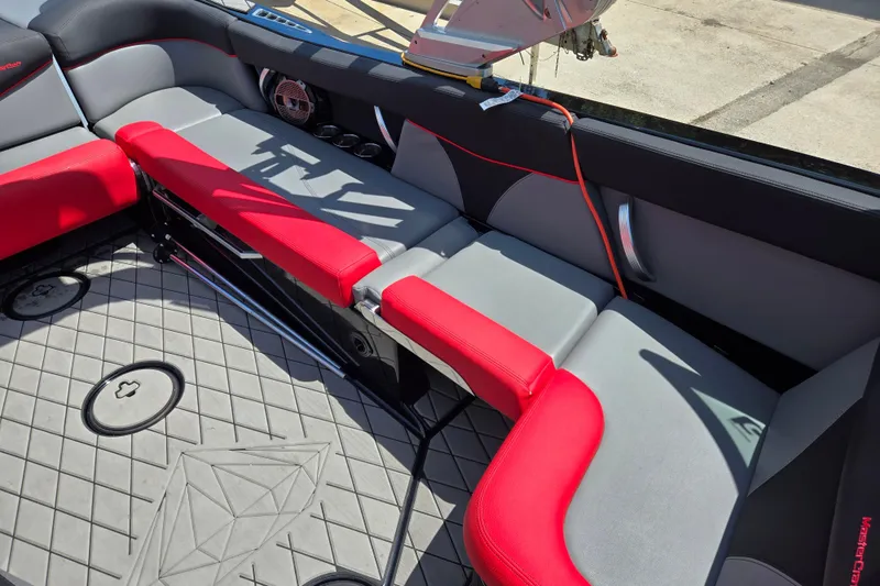 Slide: The Image of 2019 MasterCraft XT25 boat interior with red and gray seating, showcasing modern design. - 41