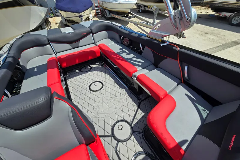 Slide: The Image of 2019 MasterCraft XT25 boat interior with red and gray seating, diamond-patterned flooring. - 42