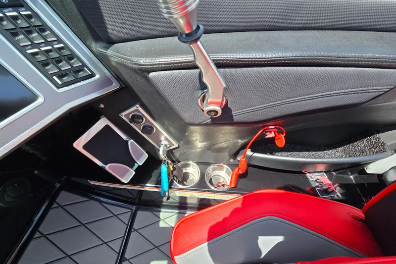 Slide: The Image of Interior of 2019 MasterCraft XT25 boat with control panel and red-accented seating. - 46