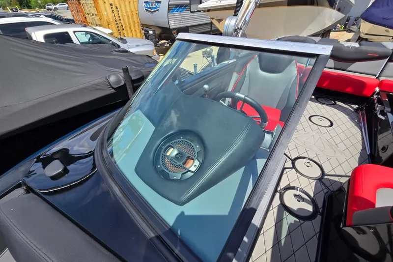 Slide: The Image of 2019 MasterCraft XT25 boat interior with red and gray seating, visible steering wheel. - 47