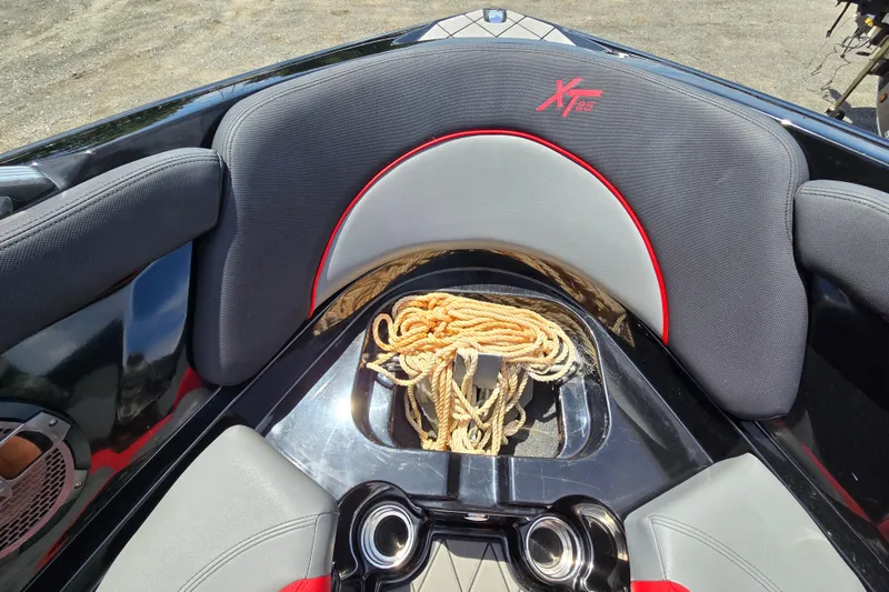Slide: The Image of 2019 MasterCraft XT25 boat interior with seating and rope storage. - 50
