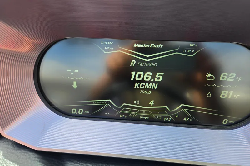 Slide: The Image of Dashboard display of a 2019 MasterCraft XT25 showing FM radio and temperature. - 61