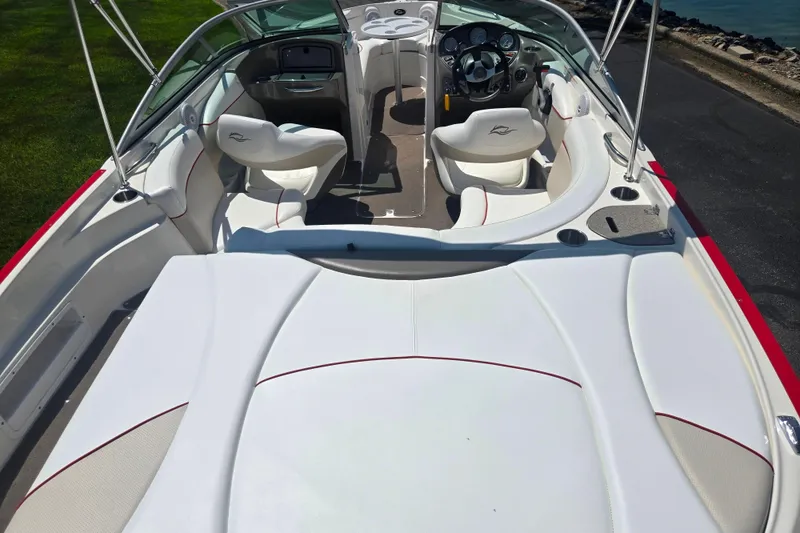 Slide: The Image of 2008 Rinker 226 Captiva Bowrider interior with white seating and modern dashboard. - 10