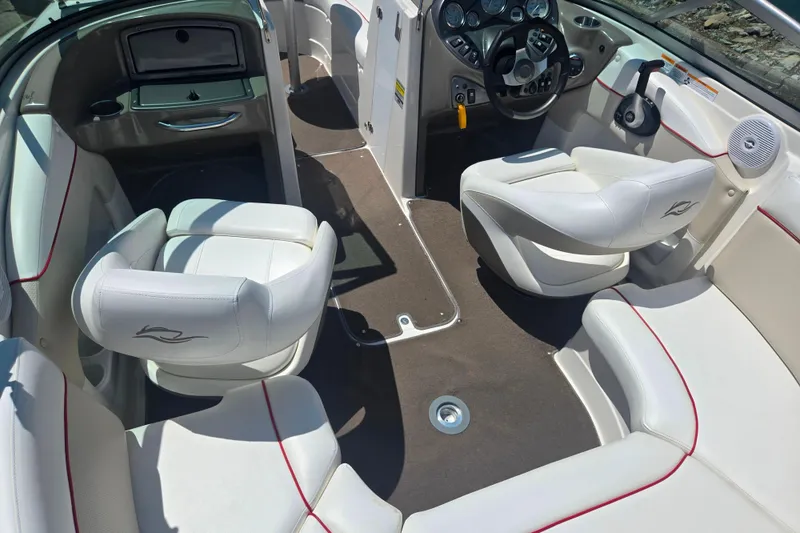 Slide: The Image of 2008 Rinker 226 Captiva Bowrider interior with white seating and modern dashboard. - 11