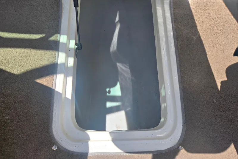Slide: The Image of Storage compartment of a 2008 Rinker 226 Captiva Bowrider boat, open and empty. - 13