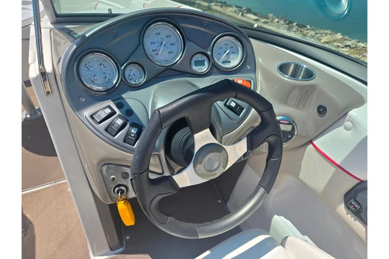 Slide: The Image of Steering console of a 2008 Rinker 226 Captiva Bowrider with gauges and controls. - 14