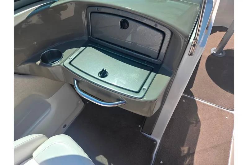 Slide: The Image of 2008 Rinker 226 Captiva Bowrider interior with storage compartment and cup holder. - 16