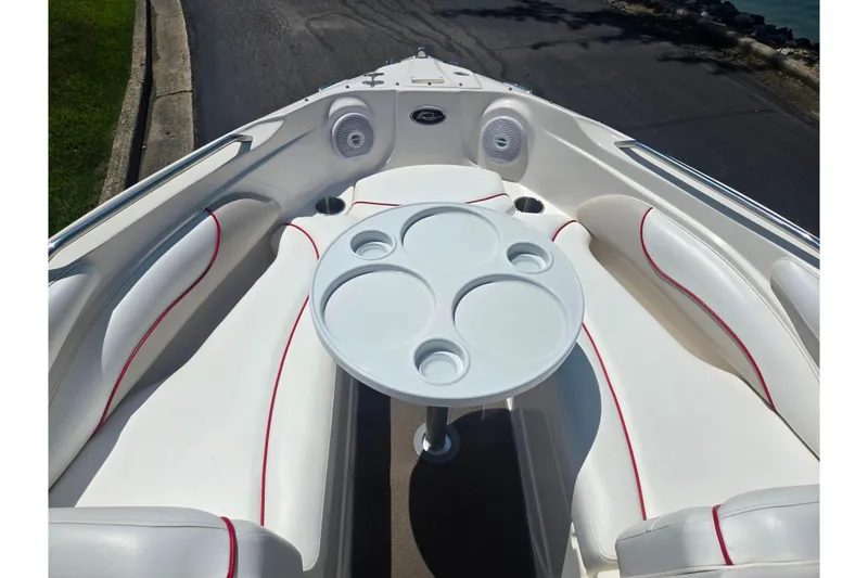 Slide: The Image of 2008 Rinker 226 Captiva Bowrider interior with white seating and round table. - 18